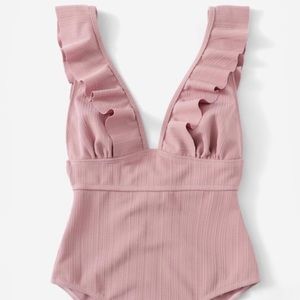 Plunge neck ruffle one piece.